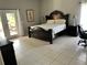 Bedroom with dark furniture and a private access to a patio at 11545 Kent Grove Dr, Spring Hill, FL 34610