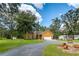 Charming single-story home with a well-manicured lawn and a long driveway at 11545 Kent Grove Dr, Spring Hill, FL 34610