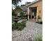 Landscaped front yard with a stone water fountain and a variety of plants at 11545 Kent Grove Dr, Spring Hill, FL 34610