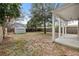 Large backyard featuring mature trees, a shed, and a covered patio at 1211 E Giddens Ave, Tampa, FL 33603