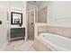 Modern bathroom with a sleek vanity, glass-enclosed shower, and a luxurious soaking tub at 1211 E Giddens Ave, Tampa, FL 33603