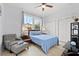 Comfortable bedroom featuring a queen bed, cozy chair, and double closets at 1211 E Giddens Ave, Tampa, FL 33603