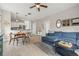 Open-concept living room featuring a comfortable blue sectional, modern decor, and an adjacent dining area at 1211 E Giddens Ave, Tampa, FL 33603