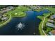 Aerial shot of community lake with fountain, golf course, and residential area at 12141 Arron Ter, Trinity, FL 34655