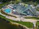 Aerial shot of community clubhouse, pool, and golf cart parking surrounded by lush landscaping at 12141 Arron Ter, Trinity, FL 34655