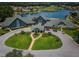 Aerial view of a community clubhouse, with a lake, golf course, and neatly landscaped grounds at 12141 Arron Ter, Trinity, FL 34655