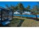 Exterior shot of the backyard with screened in lanai and a gorgeous lake view at 12141 Arron Ter, Trinity, FL 34655