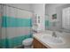 Bathroom featuring tile floors, shower with blue and white curtains, and built-in shelving at 12141 Arron Ter, Trinity, FL 34655