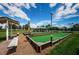 Bocce ball court featuring manicured landscaping, shaded seating, and inviting atmosphere at 12141 Arron Ter, Trinity, FL 34655