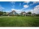 View of the clubhouse and manicured lawn, featuring lush landscaping and architectural details at 12141 Arron Ter, Trinity, FL 34655