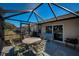 A screened lanai featuring outdoor seating, with a view of the lake at 12141 Arron Ter, Trinity, FL 34655