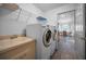 Clean laundry room features a utility sink and a washer and dryer at 12141 Arron Ter, Trinity, FL 34655