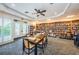 Cozy library with floor-to-ceiling bookshelves, a table for games, and outdoor access at 12141 Arron Ter, Trinity, FL 34655