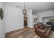 Open-concept living room featuring wood floors and a view into the kitchen at 12141 Arron Ter, Trinity, FL 34655