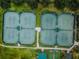 Aerial view of tennis courts, featuring eight well-maintained courts ready for play at 12141 Arron Ter, Trinity, FL 34655