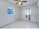 Simple bedroom with light walls and ceiling fan at 1235 45Th N St, St Petersburg, FL 33713