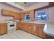 Bright kitchen with wood cabinets, white appliances, and ample counter space at 1235 45Th N St, St Petersburg, FL 33713