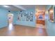 Living room with light wood floors, light blue walls, and a view of the kitchen at 1235 45Th N St, St Petersburg, FL 33713