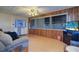 Living room with light wood floors, a sofa, and wood wall paneling at 1235 45Th N St, St Petersburg, FL 33713