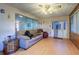 Living room with light wood floors, a sofa, and brick walls at 1235 45Th N St, St Petersburg, FL 33713