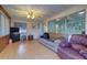 Living room with light wood floors, sofas, and a TV at 1235 45Th N St, St Petersburg, FL 33713