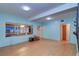 Living room with light wood floors, light blue walls, and mirrors at 1235 45Th N St, St Petersburg, FL 33713