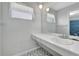 Bathroom featuring a sink, large mirror, and decorative tile floor at 14005 Leeward Dr, Seminole, FL 33776