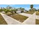 Inviting single-story home featuring a long driveway and tidy landscaping, offering great curb appeal at 14005 Leeward Dr, Seminole, FL 33776