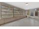 A sunroom featuring paneled walls, a concrete floor, and many windows at 14005 Leeward Dr, Seminole, FL 33776