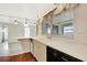 Bright kitchen featuring a double sink beneath a window with a black dishwasher and brick floor at 14005 Leeward Dr, Seminole, FL 33776