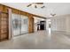 Spacious living room featuring built in wooden shelving, ceiling fans, and an open floor plan at 14005 Leeward Dr, Seminole, FL 33776