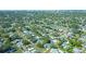 An aerial view of a residential neighborhood with mature trees; the home is identified with a green arrow at 1436 Rose St, Clearwater, FL 33756