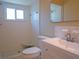 Bathroom with tiled shower, a white vanity, and a toilet at 1436 Rose St, Clearwater, FL 33756