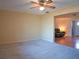 Bedroom featuring neutral carpet, a ceiling fan, and an open doorway to the living room at 1436 Rose St, Clearwater, FL 33756