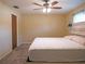 Bright bedroom features neutral walls, carpet, and a ceiling fan for added comfort at 1436 Rose St, Clearwater, FL 33756