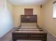 Bedroom with carpeted floors, a wooden headboard and natural light at 1436 Rose St, Clearwater, FL 33756