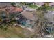 Aerial view of home featuring a screened-in pool, well-manicured lawn, and mature landscaping at 1509 Ventana Dr, Sun City Center, FL 33573