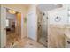 Luxurious bathroom showcasing a frameless shower and elegant travertine tile work at 1509 Ventana Dr, Sun City Center, FL 33573