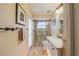 Bathroom showcasing a walk-in shower with glass door, vanity with marble countertop, and neutral tones at 1509 Ventana Dr, Sun City Center, FL 33573