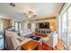 Cozy living room with hardwood floors, comfortable seating, and lots of natural light at 1509 Ventana Dr, Sun City Center, FL 33573