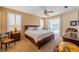 Comfortable main bedroom with plush carpet, sliding glass doors, and ceiling fan at 1509 Ventana Dr, Sun City Center, FL 33573