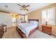 Brightly lit bedroom with carpet, ceiling fan, and connected bathroom view at 1509 Ventana Dr, Sun City Center, FL 33573