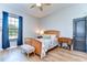 Bright bedroom with a wooden bed frame and plenty of natural light at 18531 Lithia Ranch Rd, Lithia, FL 33547