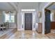 Elegant entryway with dark hardwood floors and a wooden console table at 18531 Lithia Ranch Rd, Lithia, FL 33547