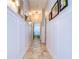 Bright hallway with wainscoting and tile flooring at 18531 Lithia Ranch Rd, Lithia, FL 33547