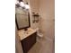 Bathroom with a vanity sink, tiled floors, a mirror, and a toilet at 21031 Sunpoint Way # 202, Lutz, FL 33558