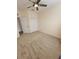 A bedroom featuring a ceiling fan, neutral carpeting, a closet, and a window at 21031 Sunpoint Way # 202, Lutz, FL 33558