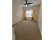 Cozy bedroom with neutral carpeting, ceiling fan, and window offering natural light at 21031 Sunpoint Way # 202, Lutz, FL 33558