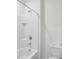 Clean white tiled shower and bathtub combo with chrome fixtures in bathroom at 2604 Knight Island Dr, Brandon, FL 33511