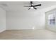 Bright bedroom featuring a ceiling fan and natural light from a window at 2604 Knight Island Dr, Brandon, FL 33511